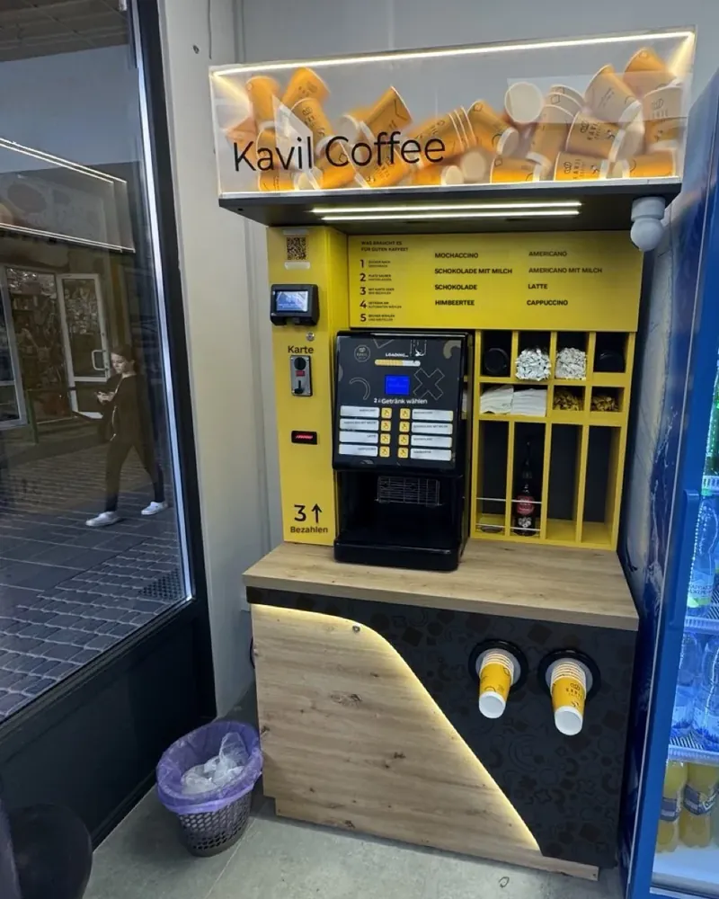 Kavil self-service coffee shop in the entrance vestibule of a grocery store, real photo